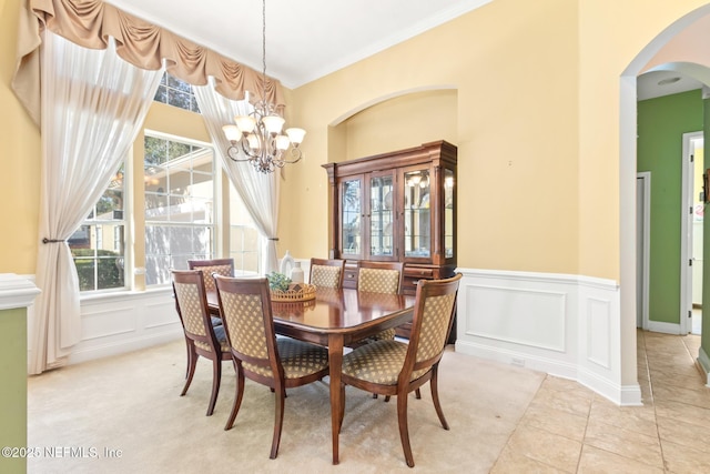 dining room featuring crown molding, a chandelier, and light tile patterned floors