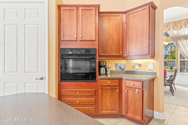 kitchen featuring oven and light tile patterned flooring