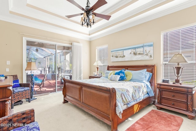 bedroom featuring crown molding, ceiling fan, a tray ceiling, light carpet, and access to outside