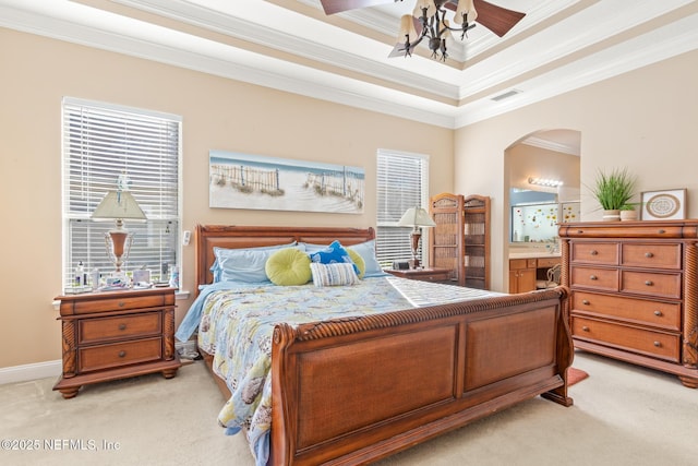 bedroom featuring ornamental molding, connected bathroom, light carpet, and multiple windows