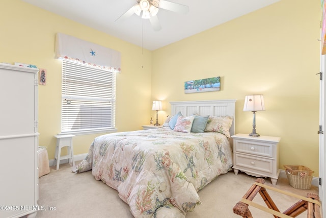 bedroom with ceiling fan and light carpet