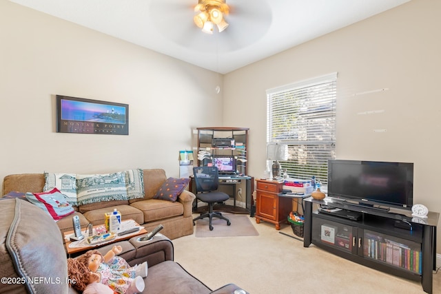 carpeted office space featuring ceiling fan