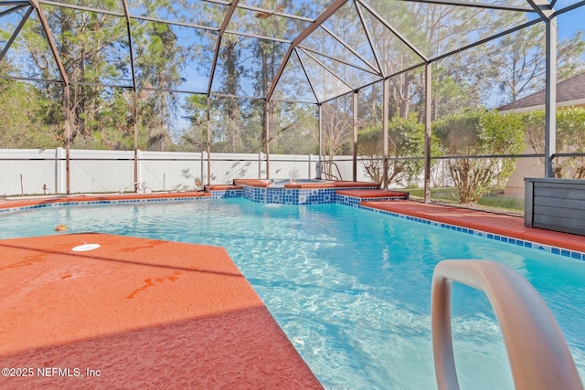 view of pool with an in ground hot tub and glass enclosure