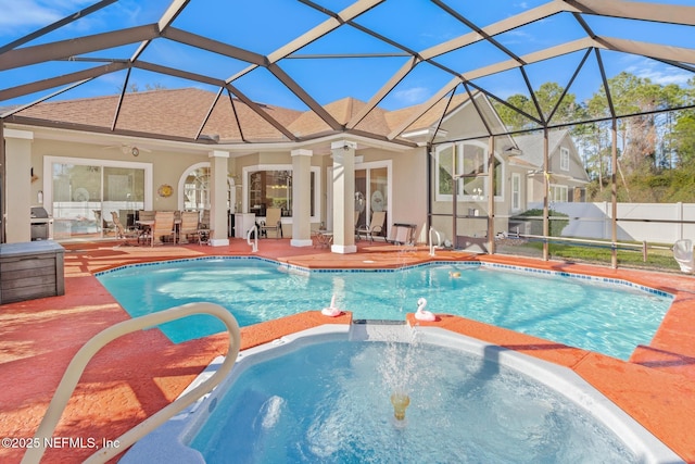 view of swimming pool with a lanai, ceiling fan, and a patio area