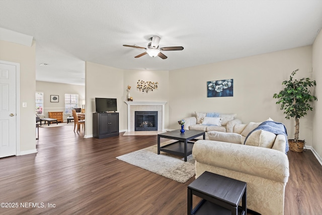 2360 Golfview Dr, Fleming Island, FL 32003 - living room featuring ceiling fan, dark wood-type flooring, baseboards, and a tile fireplace