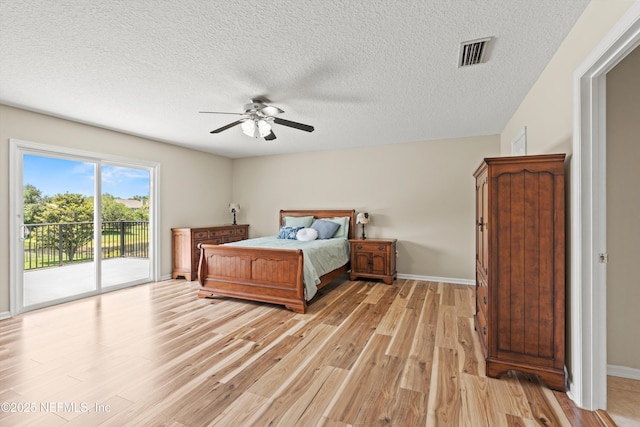 2360 Golfview Dr, Fleming Island, FL 32003 - bedroom featuring access to outside, light wood finished floors, baseboards, a textured ceiling, and ceiling fan