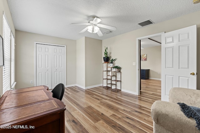 2360 Golfview Dr, Fleming Island, FL 32003 - office space with ceiling fan, light wood-type flooring, healthy amount of natural light, baseboards, and a textured ceiling