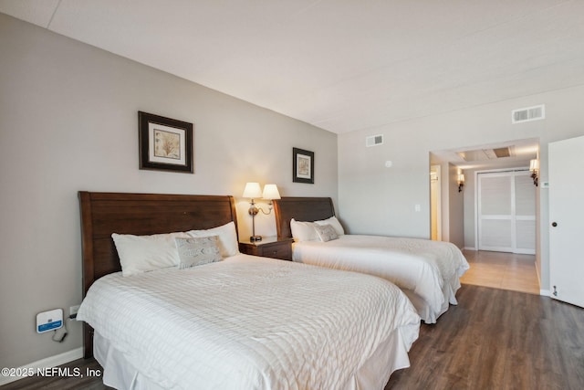 bedroom with dark hardwood / wood-style flooring