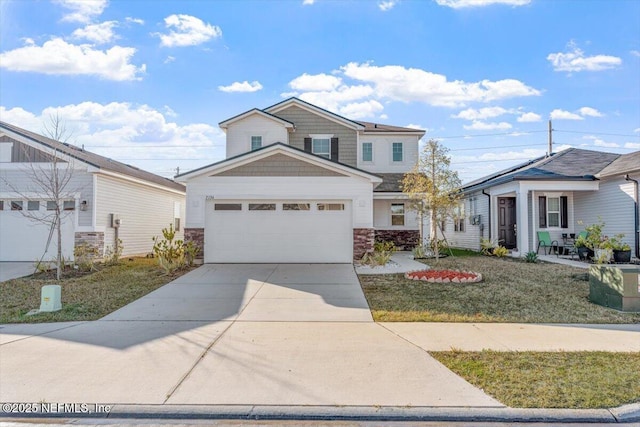 view of property featuring a garage and a front lawn