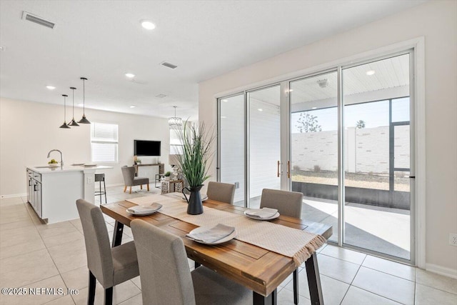 dining space with sink and light tile patterned floors