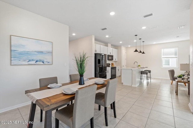 dining area featuring light tile patterned flooring and sink