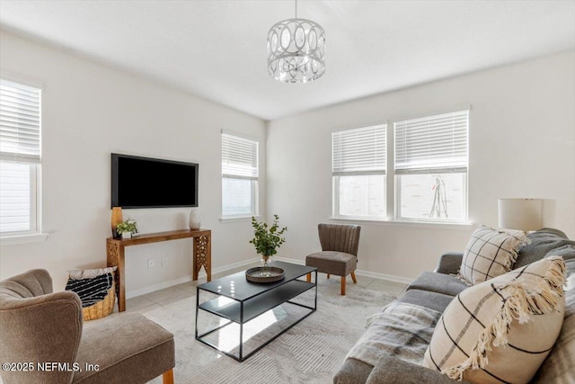 tiled living room with plenty of natural light and a notable chandelier