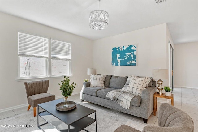 living room featuring light tile patterned flooring and an inviting chandelier