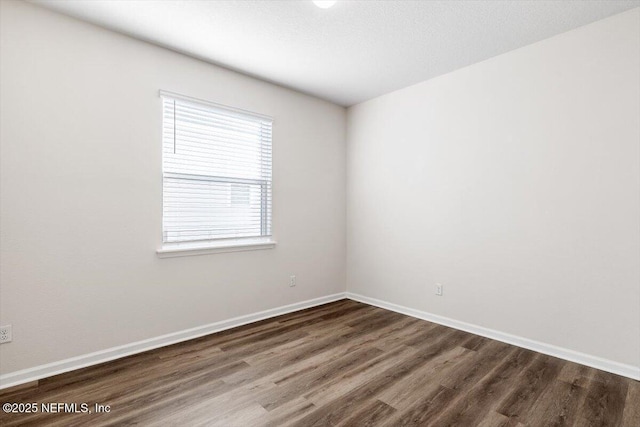 spare room featuring hardwood / wood-style floors