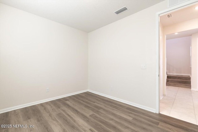 unfurnished room with dark wood-type flooring