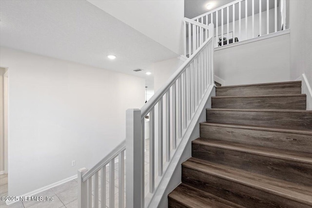 stairs with tile patterned floors