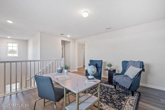 living area featuring hardwood / wood-style floors and a textured ceiling