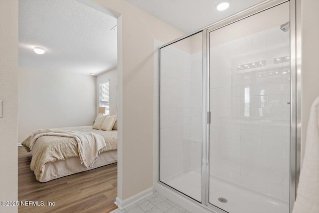 bathroom featuring an enclosed shower and wood-type flooring