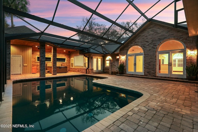 pool featuring a patio, french doors, and a lanai