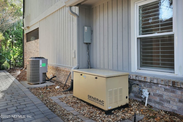 exterior details with central air condition unit, brick siding, and a power unit