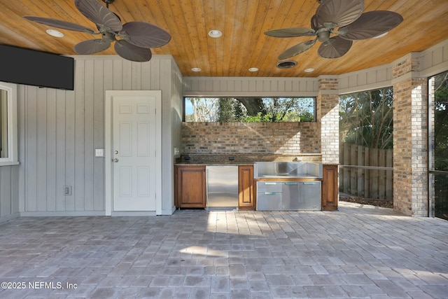 view of patio / terrace featuring area for grilling, fence, visible vents, and ceiling fan