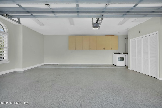 garage with washer / clothes dryer, a garage door opener, and baseboards