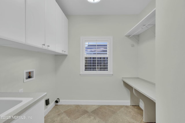 laundry area with cabinet space, baseboards, and washer hookup