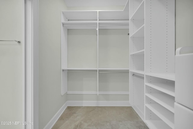 spacious closet with tile patterned floors