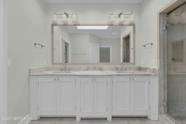 bathroom with a sink, a shower stall, and double vanity