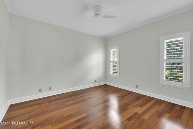 spare room with ceiling fan, baseboards, dark wood-style floors, and crown molding