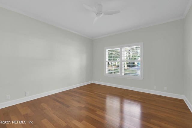 empty room with ceiling fan, baseboards, wood finished floors, and crown molding