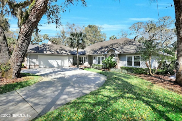 ranch-style home with driveway, a front yard, and an attached garage