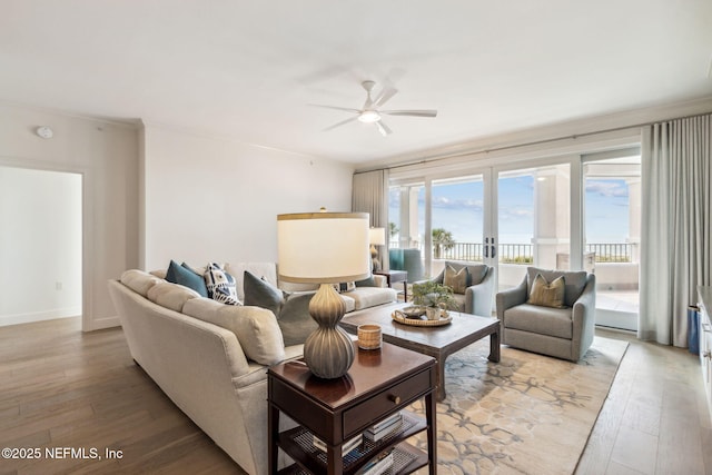 living room featuring light hardwood / wood-style floors, french doors, and ceiling fan