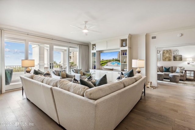 living room featuring crown molding, hardwood / wood-style flooring, and ceiling fan