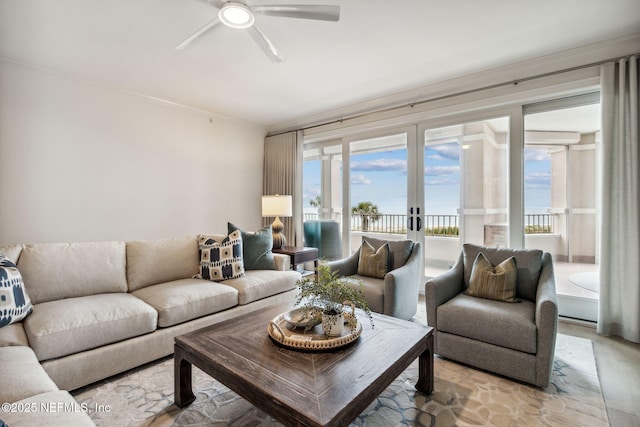 living room featuring french doors, ceiling fan, and a water view