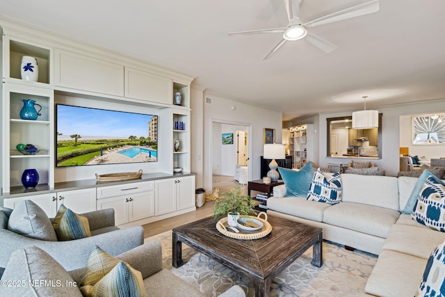 living room featuring ceiling fan and light wood-type flooring