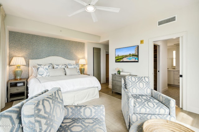 bedroom with connected bathroom and ceiling fan