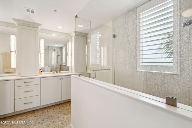 bathroom featuring vanity and a shower with shower door