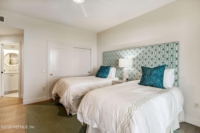 bedroom featuring hardwood / wood-style floors and a closet