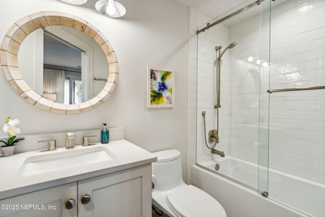 full bathroom with vanity, toilet, and combined bath / shower with glass door