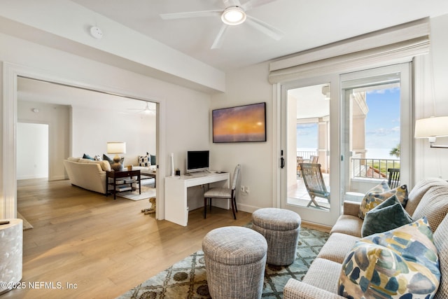 living room with ceiling fan and light hardwood / wood-style flooring