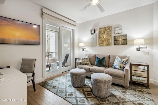 living room with light hardwood / wood-style floors and ceiling fan