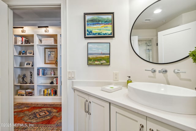 bathroom featuring vanity and built in shelves