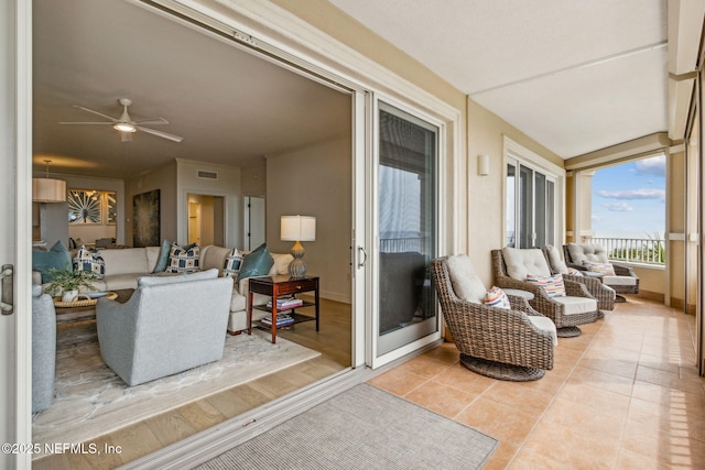 sunroom featuring ceiling fan