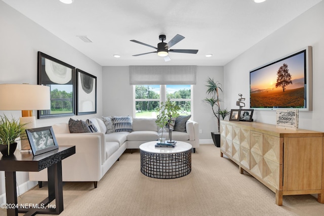 carpeted living room featuring ceiling fan