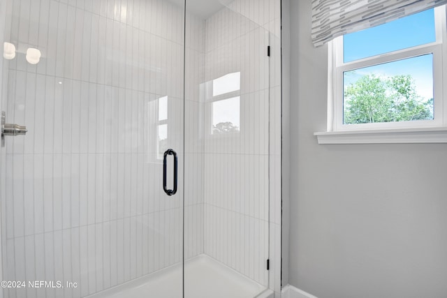 bathroom featuring a shower with shower door