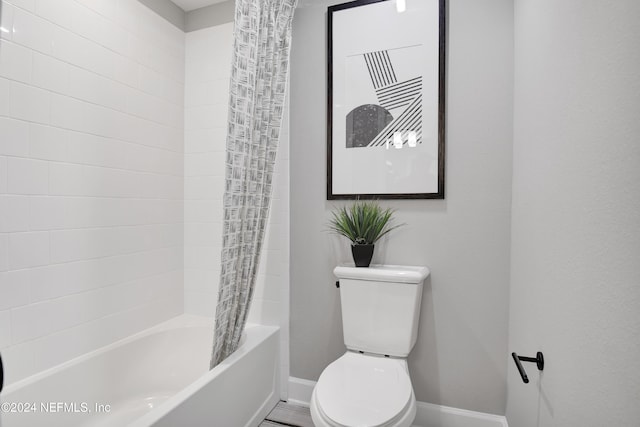 bathroom featuring shower / bathtub combination with curtain and toilet