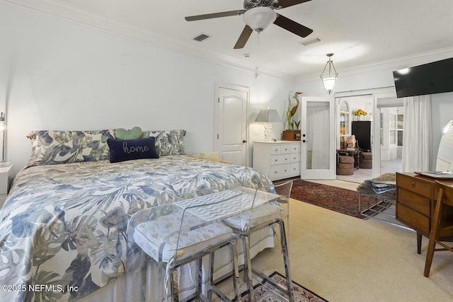 carpeted bedroom with ornamental molding and french doors