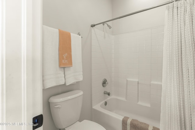 full bath with shower / tub combo and toilet