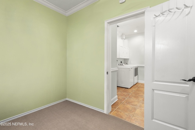 hall with light tile patterned floors, baseboards, light colored carpet, crown molding, and separate washer and dryer